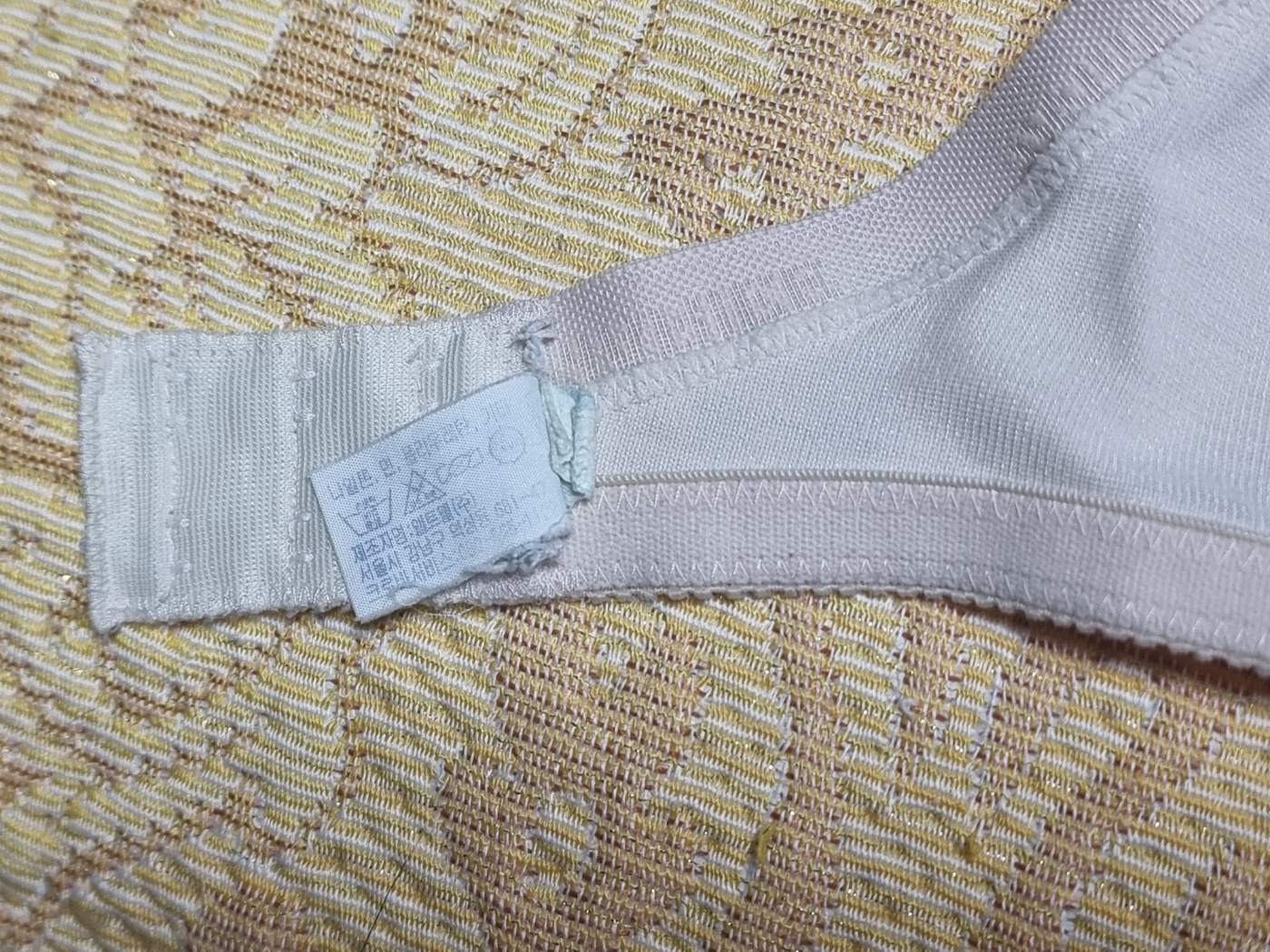 A close-up of the back clasp of an aged but durable Korean bra, a common point of failure, still strong and functional.