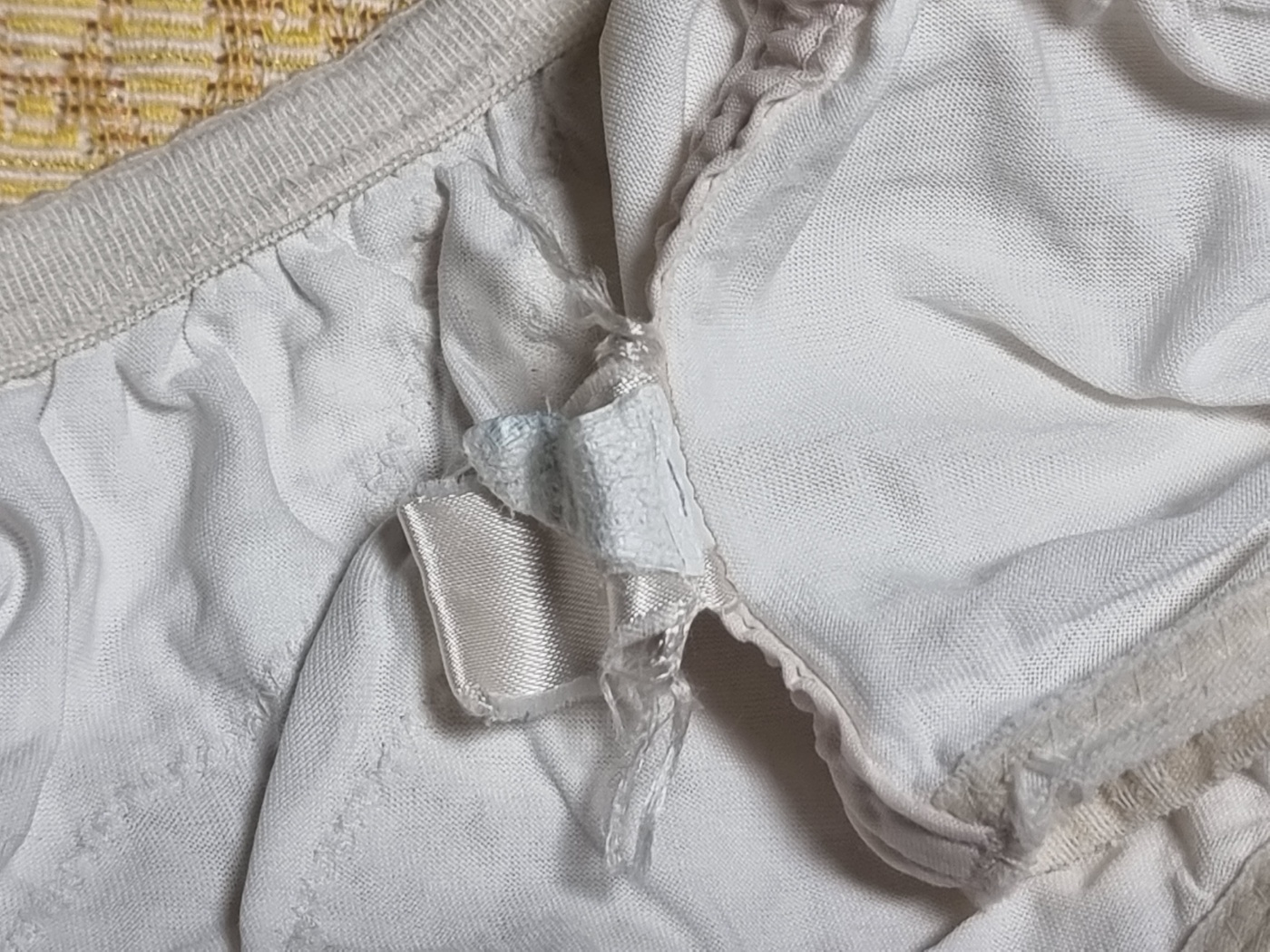 A close-up of a tattered and unreadable label on a 25-year-old Korean panty.