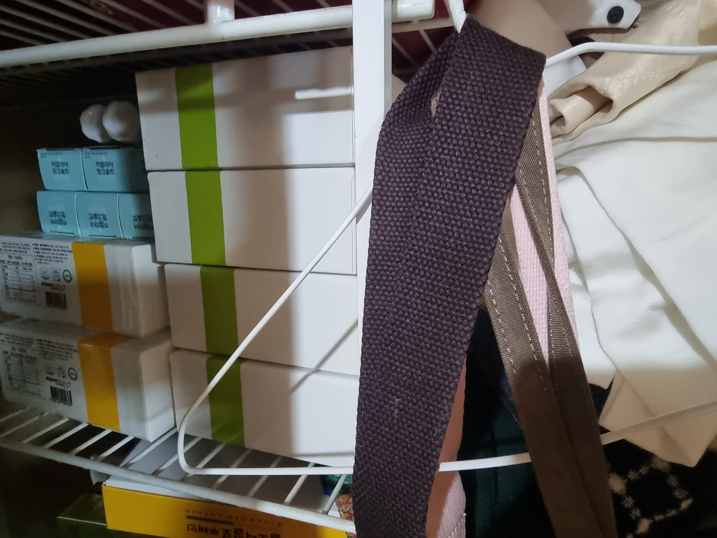 Four boxes of the discontinued spirulina product, with the 2017 expiration date, sitting in a home storage container.